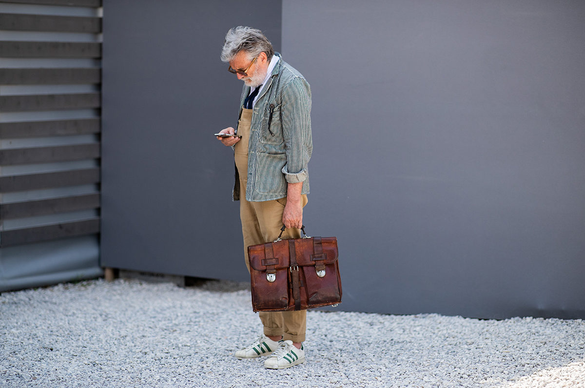 FLORENCE, ITALY - JUNE 12: A guest wearing beige brown overall, hand bag is seen during the 94th Pitti Immagine Uomo on June 12, 2018 in Florence, Italy (Photo by Christian Vierig/Getty Images)